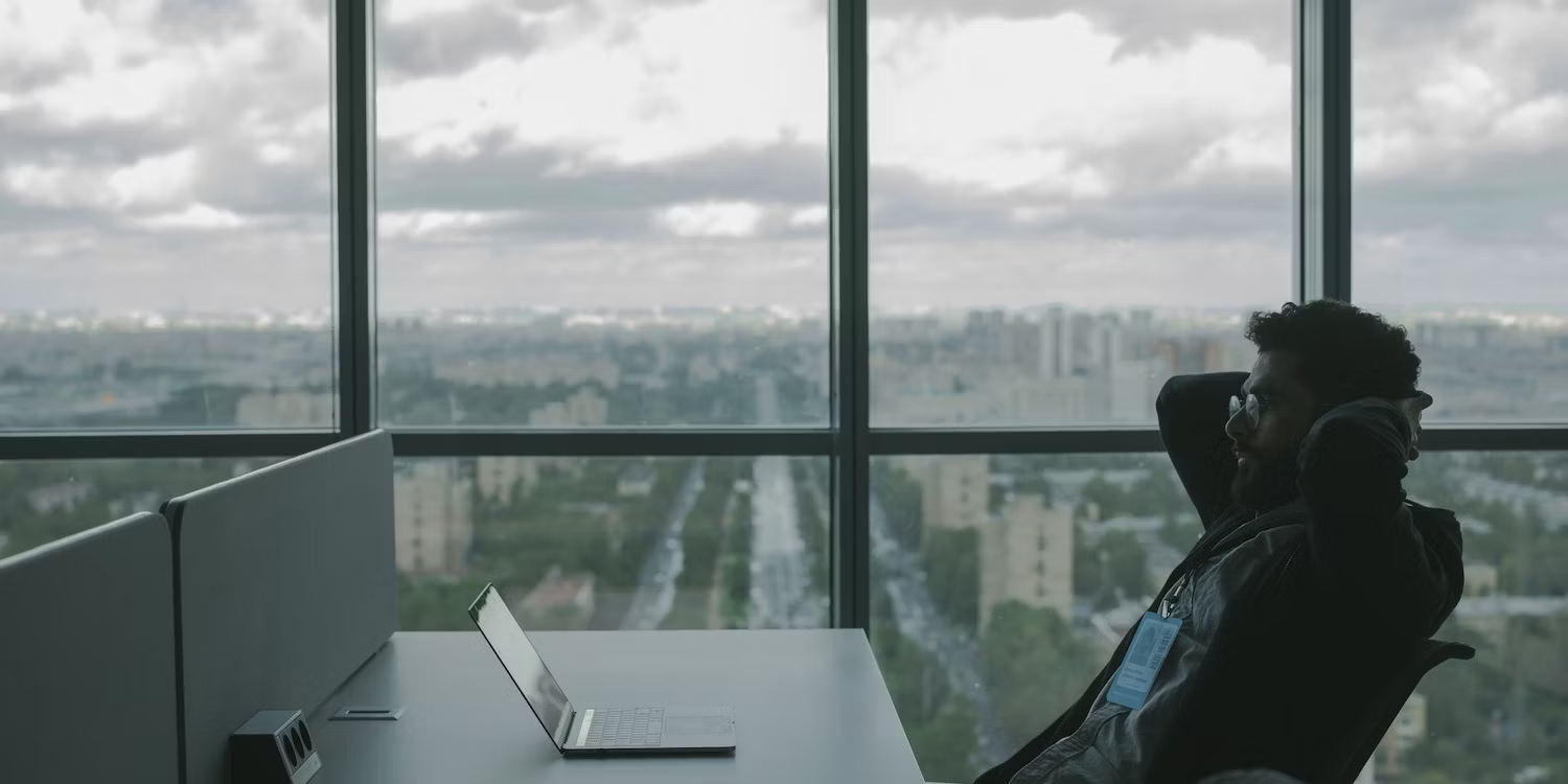 Man-Reclining-and-Looking-at-his-Laptop